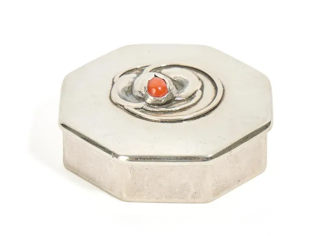 A small case, lid enchased with flower fitted with coral. Gilded interior. Made and marked by Evald Nielsen, 1919. Weight 40 g. H. 2 cm. Diam. 5.5 cm.
