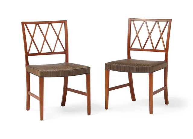 A pair of teak chairs with cross stretchers in the back. Seat upholstered with brown striped horsehair with brown leather piping. Made 1950–1960s by cabinetmaker A.J. Iversen, with metal plaque from Illums Bolighus. (2)