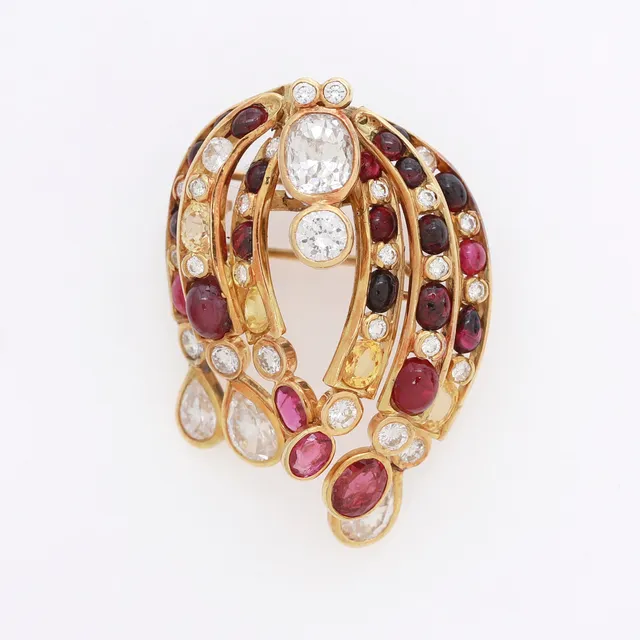 Gold and gemstones brooch, circa 1980.