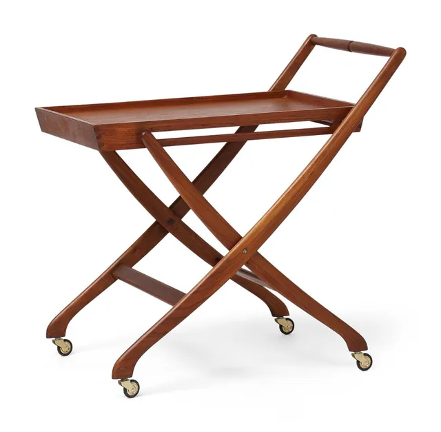 A foldable teak serving cart with castors of brass. Presumably manufactured by K. Knudsen & Søn. H. 63/72. L. 70. W. 50 cm.