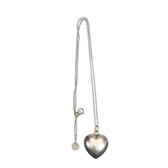 TIFFANY & CO. SILVER HEART SHAPED PENDANT, ON A STERLING SILVER CHAIN WITH A TIFFANY & CO. SILVER CIRCULAR TAG.