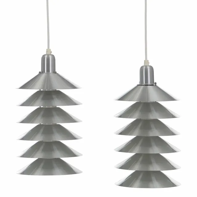 “Tip Top”. A pair of brushed-steel pendants with white lacquered insides. Manufactured by Pandul. H. 25. Diam. 20 cm. (2)