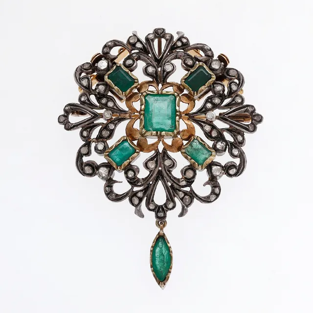 Emeralds and diamonds brooch-pendant in Historicist style.