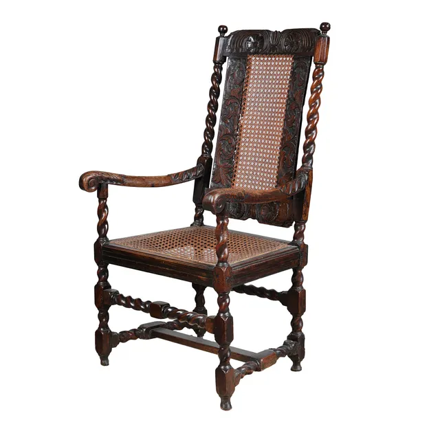 AN 18TH CENTURY WALNUT AND CANE BACKED HIGH ARMCHAIR.