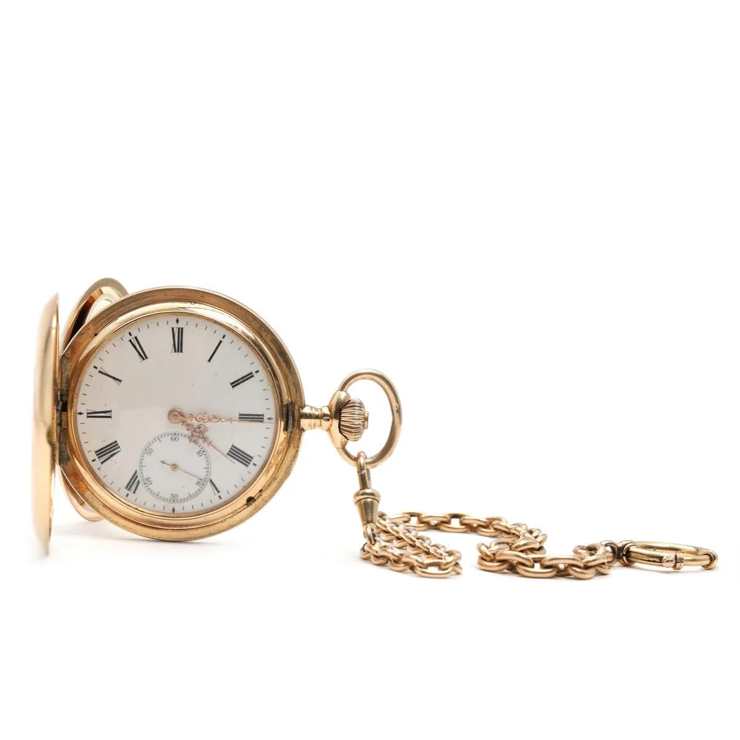 Double-cased pocket watch of 14k gold, case no. 692134. Mechanical movement with lever escapement and crown winding. White enamel dial with Roman numerals and gilt hands. Dust cap of 14k gold. Weight of watch app. 108 g. Ø 53 mm. Accompanied by chain of 14k gold. Weight app. 31 g. L. 29 cm. — Clocks & watches/Pocket Watches — Bruun Rasmussen