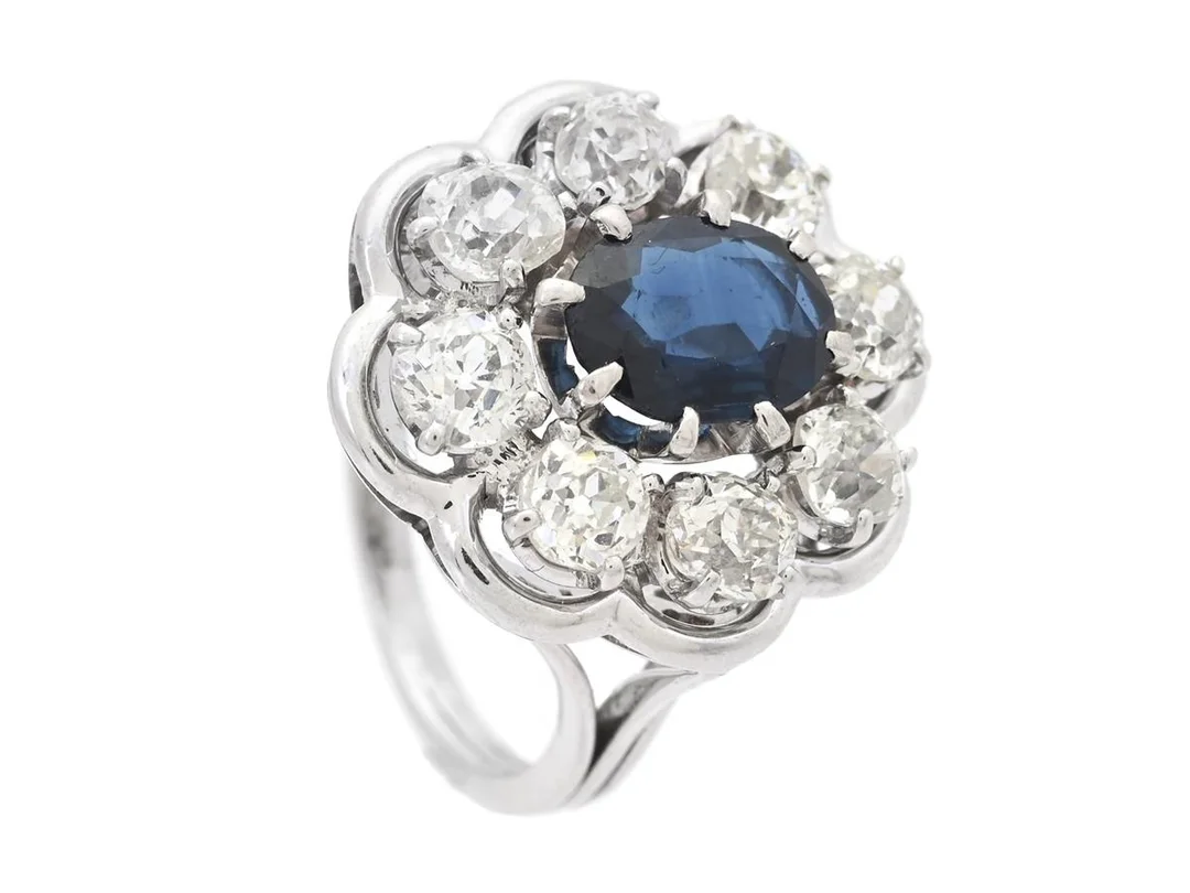 RING, 18K vitguld, blå safir ca 1,35 ct, 8 gammalslipade diamanter ca 1,75 ctv, ca TCa/SI-P, stl 16 mm, vikt 7,1 g, diamanter med mindre skador och nagg. — Smycken/Ring — Kaplans