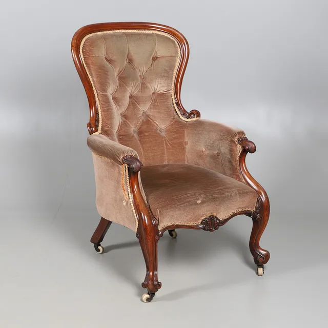 A VICTORIAN CARVED WALNUT SHOWFRAME ARMCHAIR.