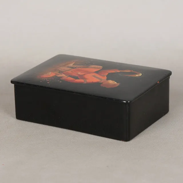A RUSSIAN BLACK LACQUERED BOX AND COVER.