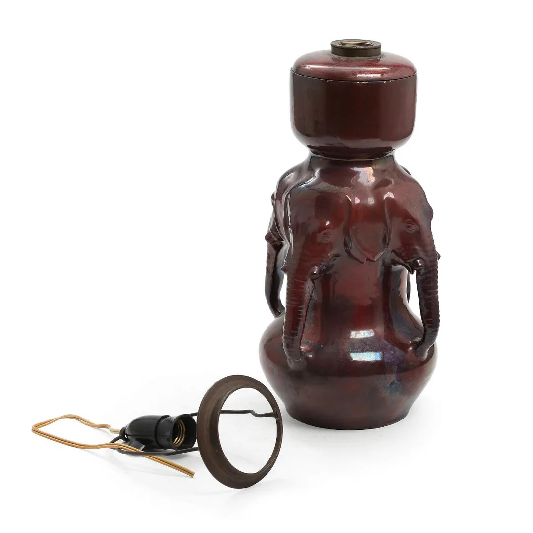 Karl Hansen Reistrup: An earthenware lamp modelled with elephant heads, decorated in red lustre glaze. Signed HAK and marked Denmark. H. 44 cm. — Modern Decorative Art — Bruun Rasmussen
