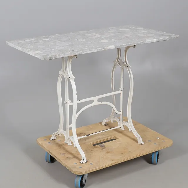 A 19TH CENTURY PAINTED CAST IRON AND FOSSILIZED MARBLE TOPPED TABLE.