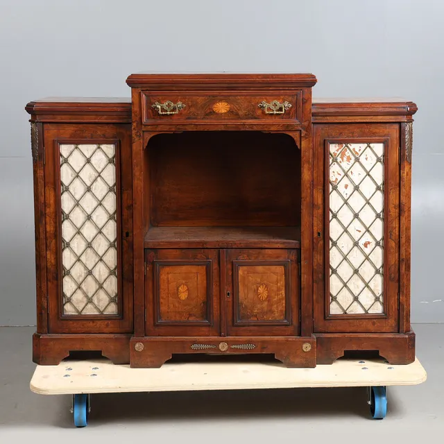 A 19TH CENTURY FIGURED WALNUT BREAKFRONT CABINET, CIRCA 1840.