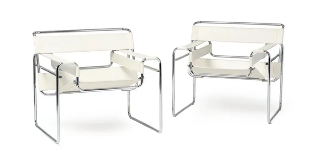 “Wassily Chair”. A pair of chromed steel easy chairs, with white leather. Designed 1925. Manufactured and marked by Fasem, Italy. (2)