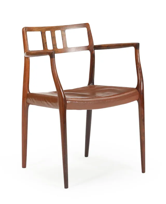 A rosewood armchair upholstered in seat with brown leather. Model 64. Designed 1966. Manufactured and marked by J. L. Møller, Højbjerg.