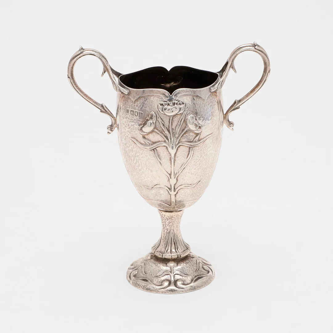 AN EDWARDIAN ART NOUVEAU TWO-HANDLED CUP. — Silver — Lawrences Auctioneers