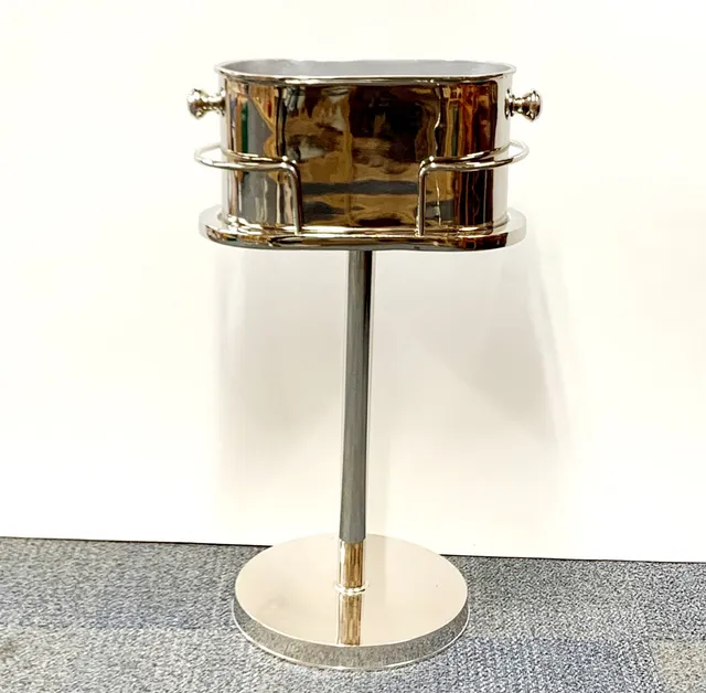 SILVERED METAL ICE BUCKET AND STAND.