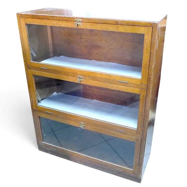 A MID CENTURY OAK GLAZED BOOKCASE.