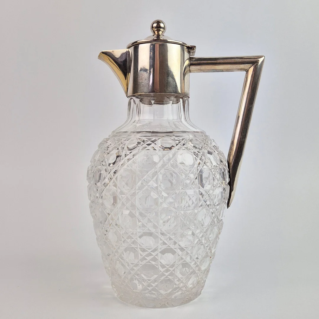 A LATE VICTORIAN SILVER AND CUT GLASS CLARET JUG. — Silver — Lots Road Auctions