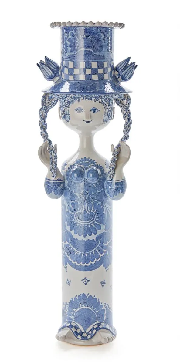 An earthenware flower stand/sculpture, modelled in the shape of a womans' figure. Decorated with blue glazed decor on a light grey glazed base. Signed Bjørn Wiinblad 86. H. 74.5 cm.