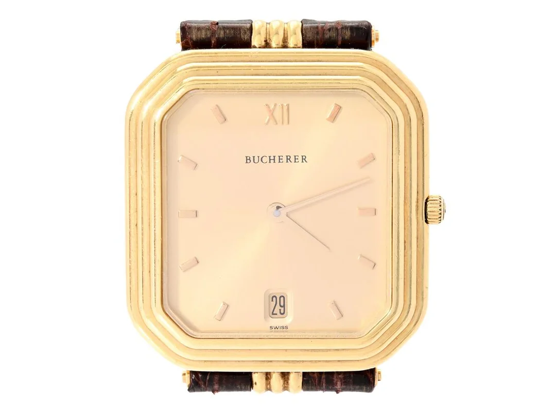 BUCHERER, herrur, 29,5 x 31 (36) mm, Boett nr. 255.023 / 8908 (CB), 18K guld, quartz, safirglas, integrerat läderband, cert (ej komplett), ca mars 1990. — Klockor/Bucherer — Kaplans