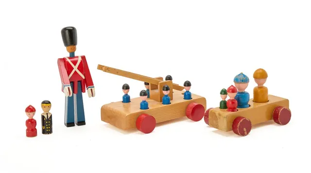 A collection of lacqeured wooden toys, comprising a guard, a fire engine, a car and 12 figures. Partially stamped Kay Bojesen, Copyright, Denmark. Variable dimensions. (5)