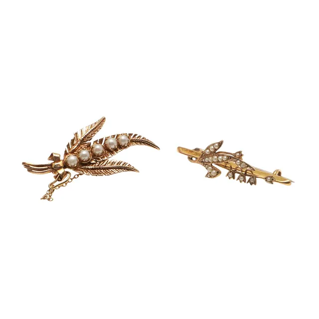 A LATE VICTORIAN 9CT GOLD AND HALF PEARL LILY OF THE VALLEY BROOCH AND ANOTHER 9CT GOLD BROOCH.