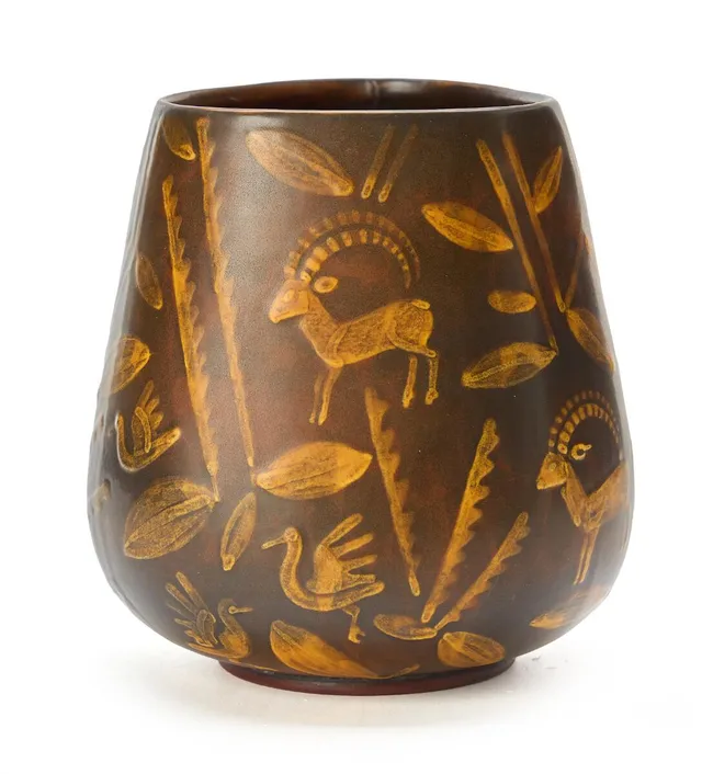 Faience vase decorated with yellow-glazed motifs on a brown base. Made by Aluminia. H. 15 cm. Diam. ca. 12 cm.