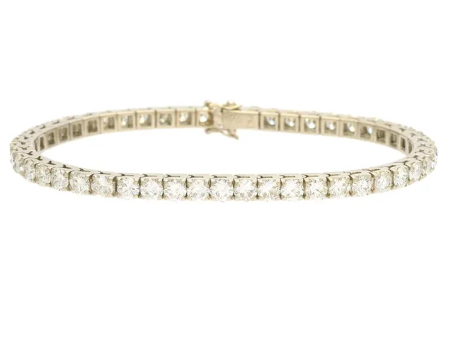 TENNISARMBAND, 18K vitguld, 49 briljantslipade diamanter ca 7,90 ctv, ca W-TCa/VVS-VS, längd 18 cm, vikt 16,9 g,några diamanter med skador och nagg.