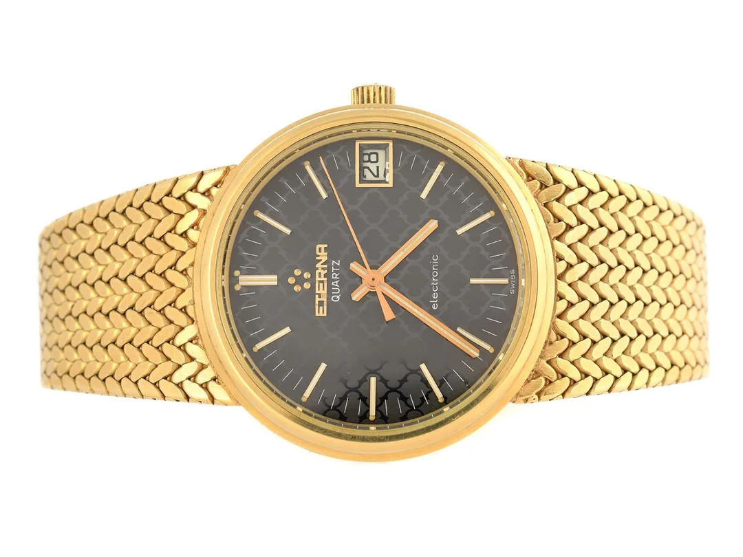 ETERNA, Electronic, Cal 1555 (ESA 9180), Boett nr. 755.3008.68, herrur, 35 mm, 18K guld, quartz, safirglas, datum, integrerad originallänk, längd 190-192 mm, totalvikt 106,6 gram, ca 1975, box. — Klockor/Eterna — Kaplans