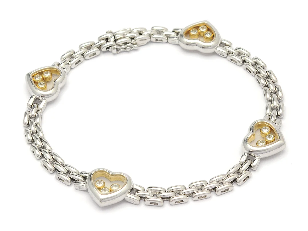 CHOPARD, armband, Happy diamonds, 18K vitguld, 12 briljantslipade diamanter ca 0,48 ctv, längd 19 cm, vikt 25 g. — Smycken/Armband — Kaplans