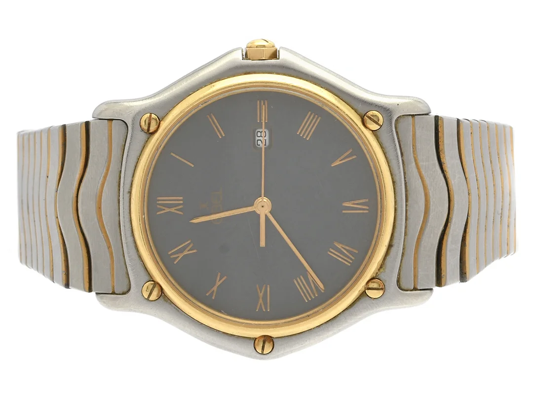 EBEL, Sport Classic, Senior, Serie nr. 14615284, Boett nr. 183903, herrur, 35 mm, stål/guld, quartz, safirglas (repor), datum, skadad urtavla, integrerad originallänk, viklås, Ref nr. 0886, längd 170 mm, ca 1986. — Klockor/Ebel — Kaplans
