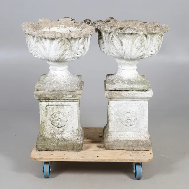 PAIR OF ACANTHUS LEAF RECONSTITUTED STONE URN PLANTERS.