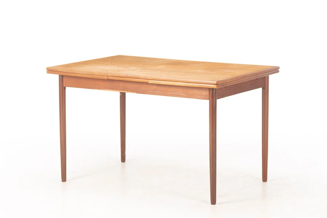 Danish furniture manufacturer. Teak dining table with extension. 1950s/60s. — Furniture/Dining tables, dining room furniture — Lauritz