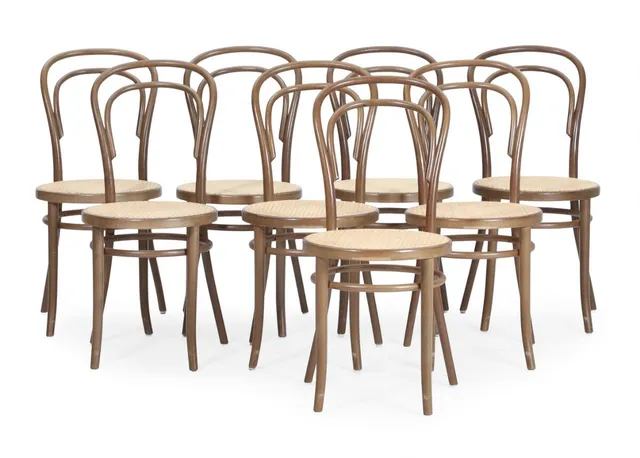 “No. 14”. Eight dark stained bentwood chairs, seats with French cane. Manufactured and marked by Fameg. (8)