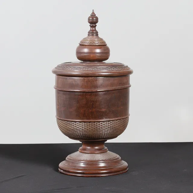 A LARGE TURNED LIGNUM VITAE WASSAIL BOWL AND COVER.