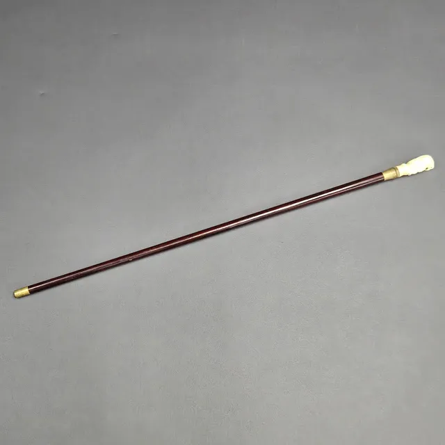 CARVED BONE HANDLED WALKING STICK.