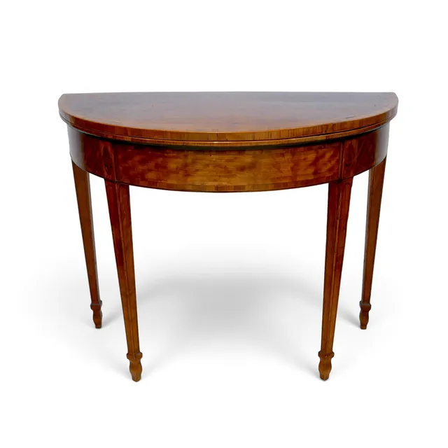 A 19TH CENTURY DEMI LUNE FOLD OVER CARD TABLE.
