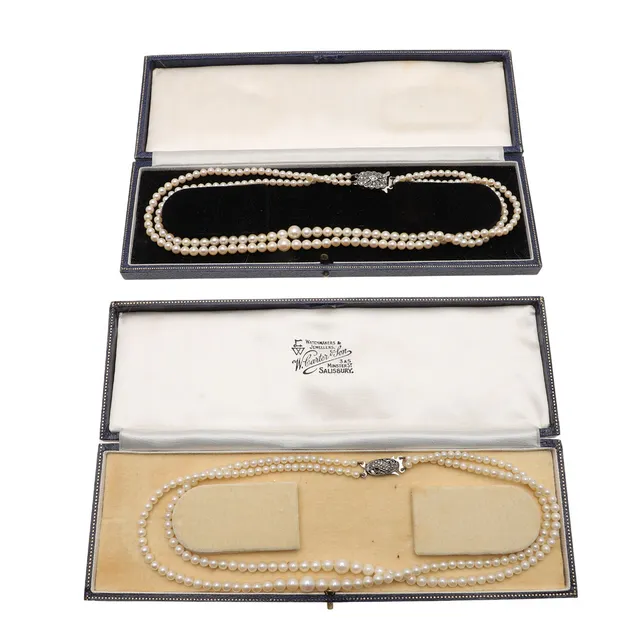 TWO EARLY 20TH CENTURY DOUBLE ROW CULTURED PEARL NECKLACES WITH SILVER AND MARCASITE CLASPS.