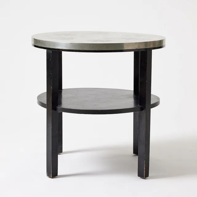 FIRMA SVENSKT TENN. Table, Stockholm 1931, model B 353, pewter top with figurine and animal scenes by Nils Fougstedt, black lacquered birch.