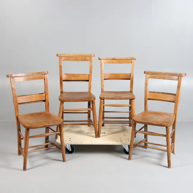 A SET FOUR EARLY 20TH CENTURY ELM SEATED CHAPEL CHAIRS (4).
