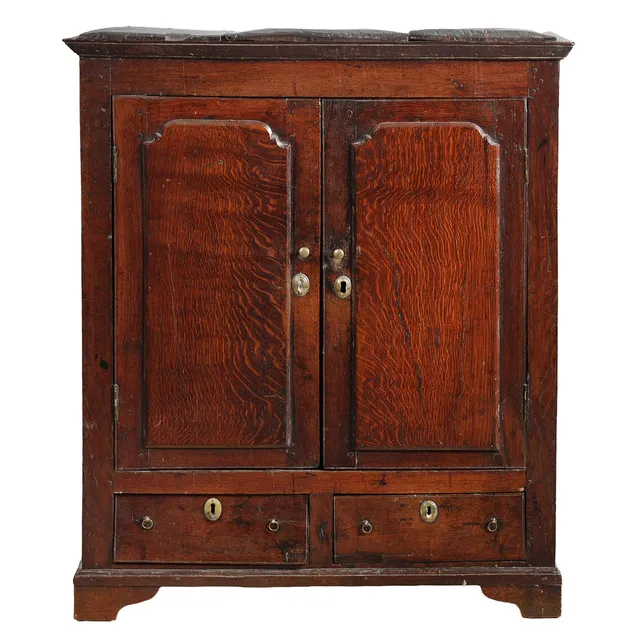 A GEORGE III OAK CABINET.