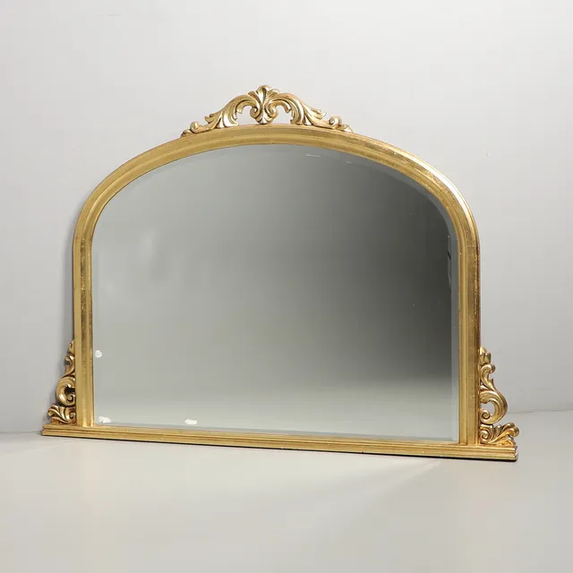 A LARGE GILT OVER MANTLE MIRROR.