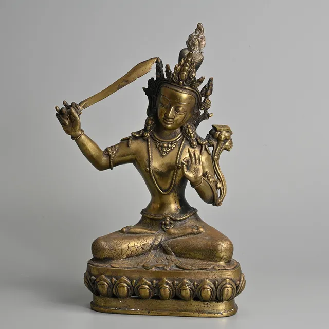 A TIBETAN BRASS FIGURE OF MANJUSHRI, 20TH CENTURY.