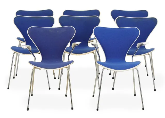 “Seven Chair”. A set of eight chairs and two armchairs with white lacquered plywood shells and chromed steel legs. Model 3107 and 3207. Designed 1955. Manufactured and marked by Fritz Hansen. (8)