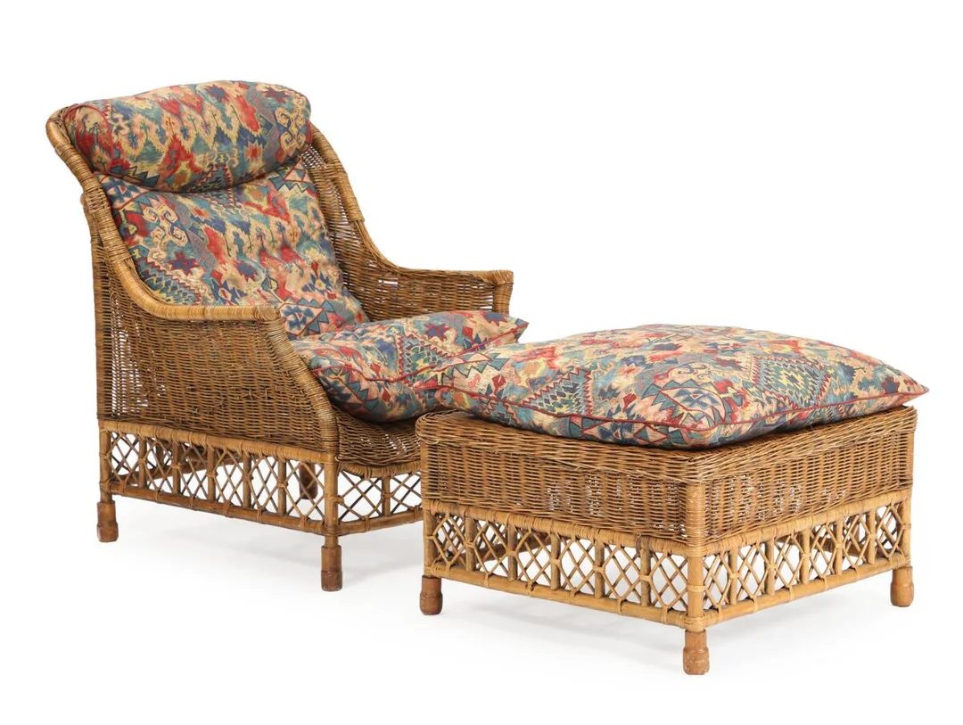 “Karen Blixen”. A woven rattan lounge chair with footstool. Loose cushions upholstered with patterned fabric. Manufactured by Søren Lund Møbler. (2) — Modern Furniture — Bruun Rasmussen