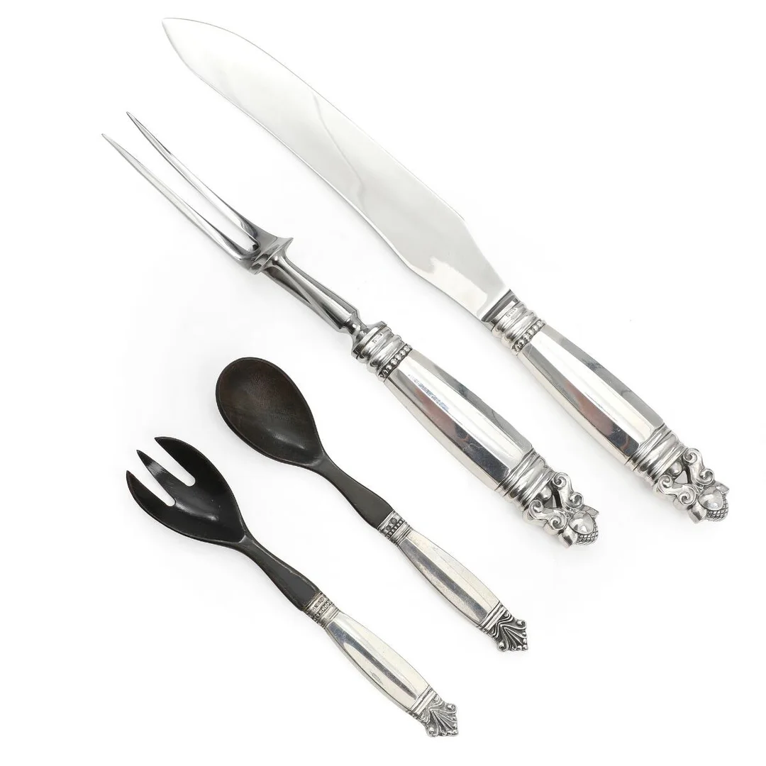 “Acorn” carving set and “Acanthus” salad set with silver and sterling silver handles. Georg Jensen 1925 and after 1945. L. 16.2–32 cm. (4) — Silver/Georg Jensen — Bruun Rasmussen