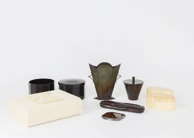 A collection of art deco boxes and vases of bakelite and bronze, 1920s-1940s (9)