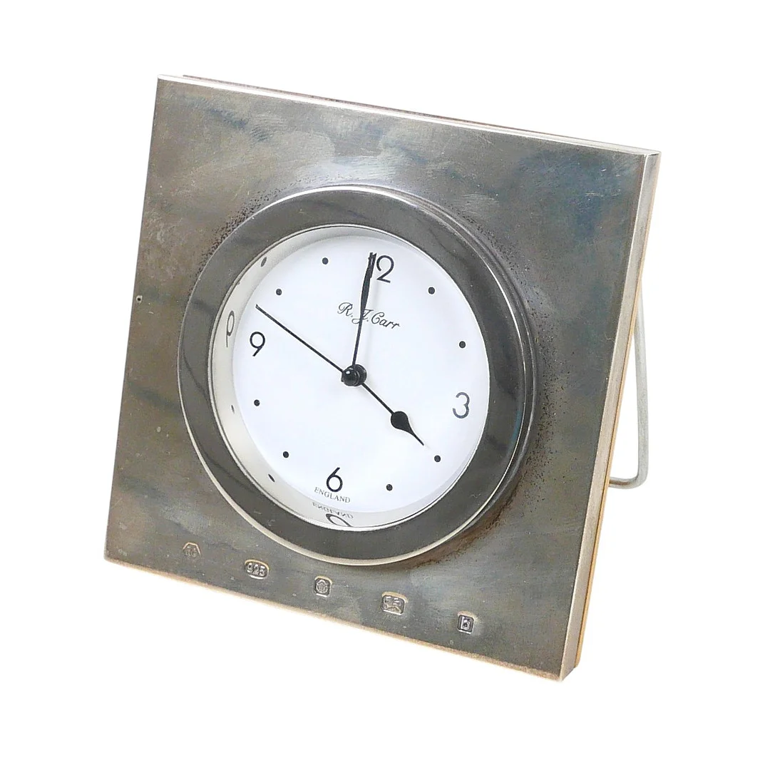 A ELIZABETH II SILVER MOUNTED TRAVEL CLOCK. — Silver — Batemans of Stamford