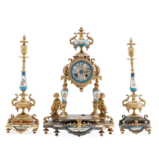 French ornament with a clock and a pair of candlesticks in gilt calamine and Sèvres-like porcelain, late 19th Century.