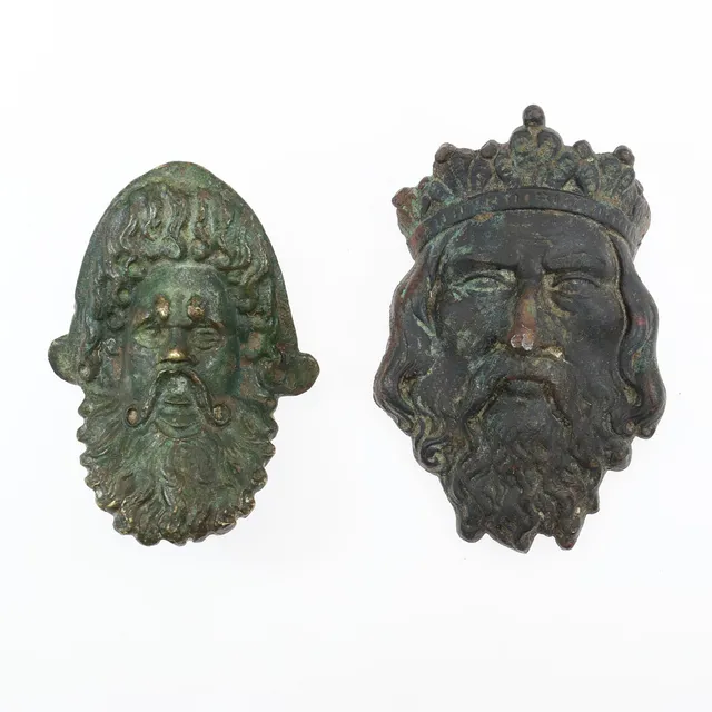 ROMAN BRONZE AND MEDIEVAL MASK MOUNTS. (2).