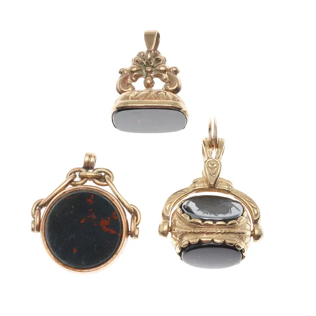 THREE ASSORTED 9CT GOLD FOB SEALS.